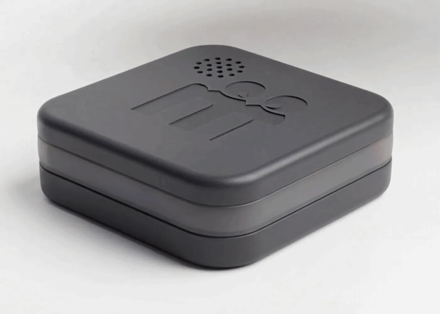 The Cookie: a small, softly rounded charcoal device with the Modem mark pressed into its lid.